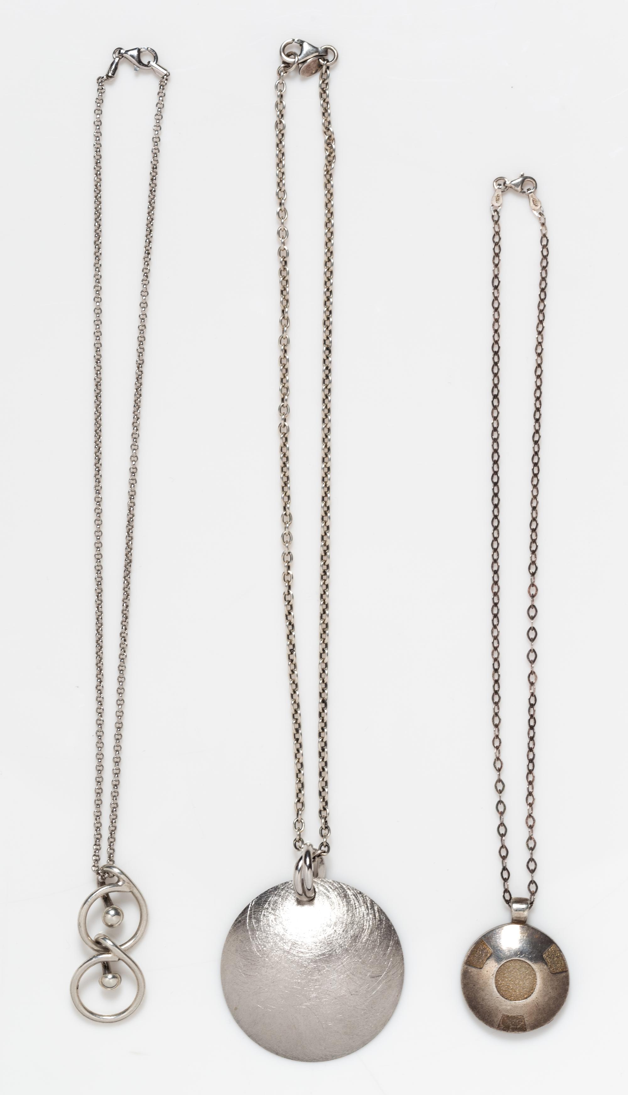 A Collection of Sterling Silver Circular Motif Pendant Necklaces, 34.60 dwts.