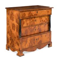 A Biedermeier Part-Ebonized Burlwood Commode