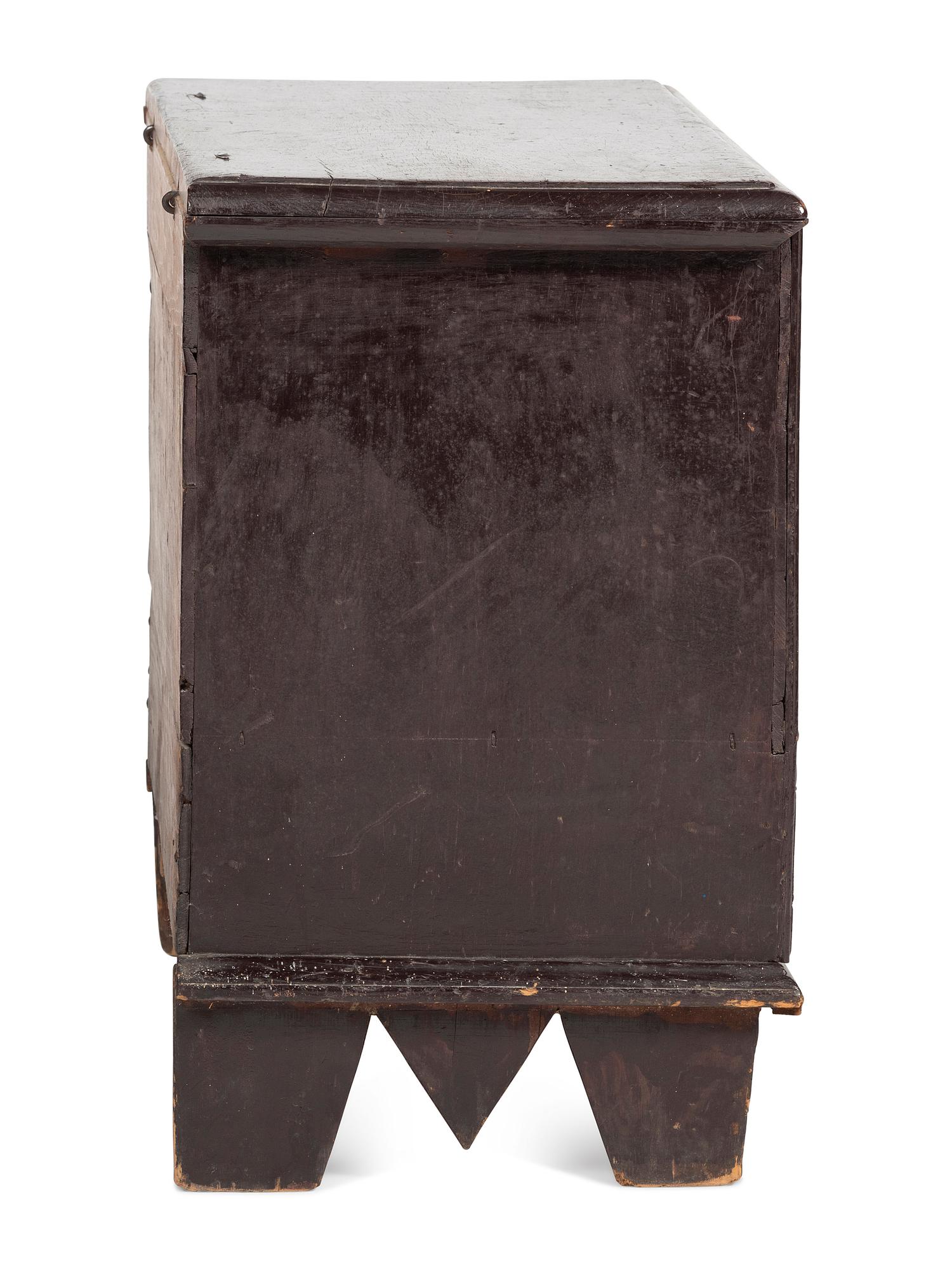 A Rare Pilgrim Century Black Painted Pine One-Drawer 'M' Chest