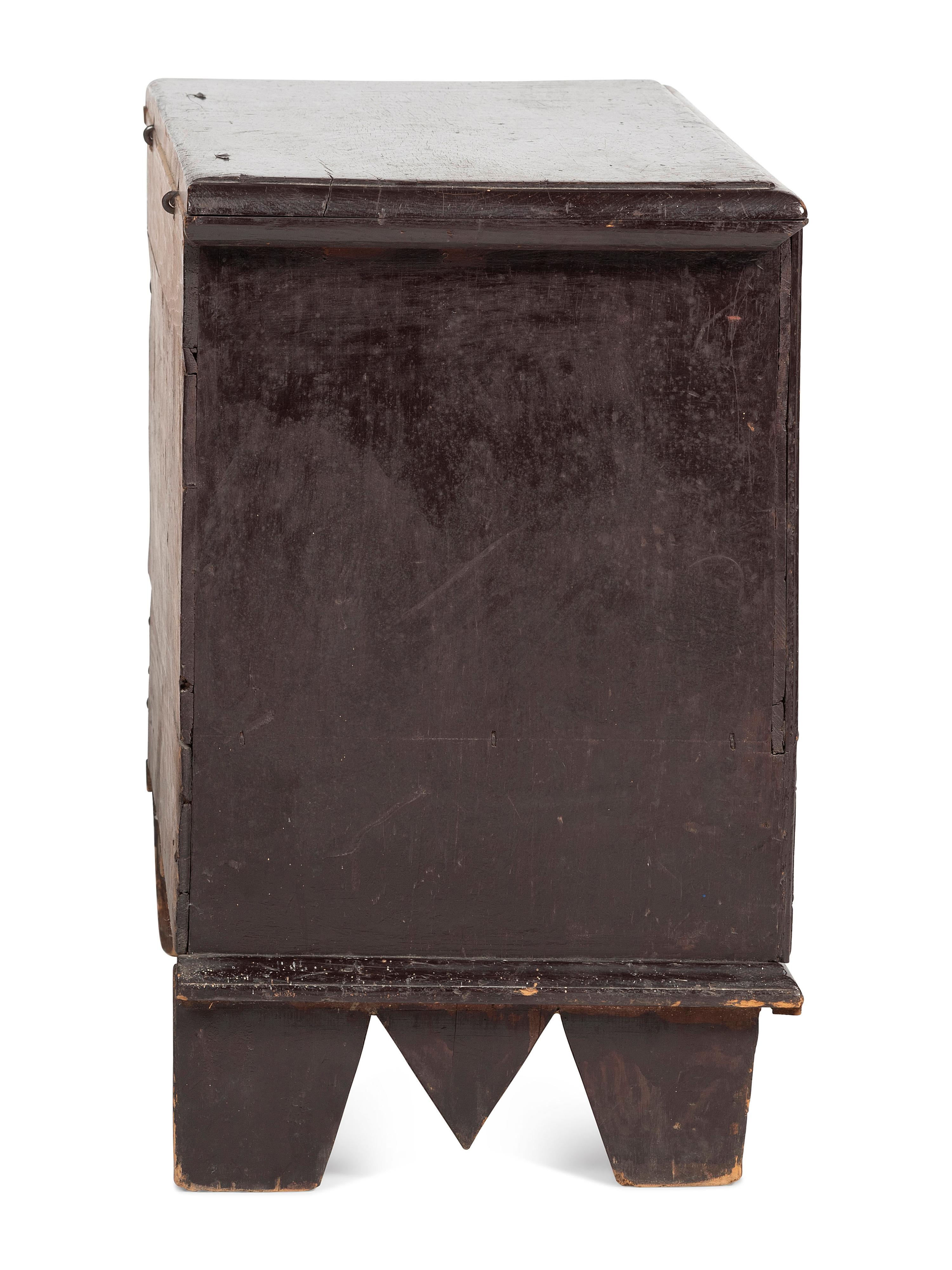 A Rare Pilgrim Century Black Painted Pine One-Drawer 'M' Chest
