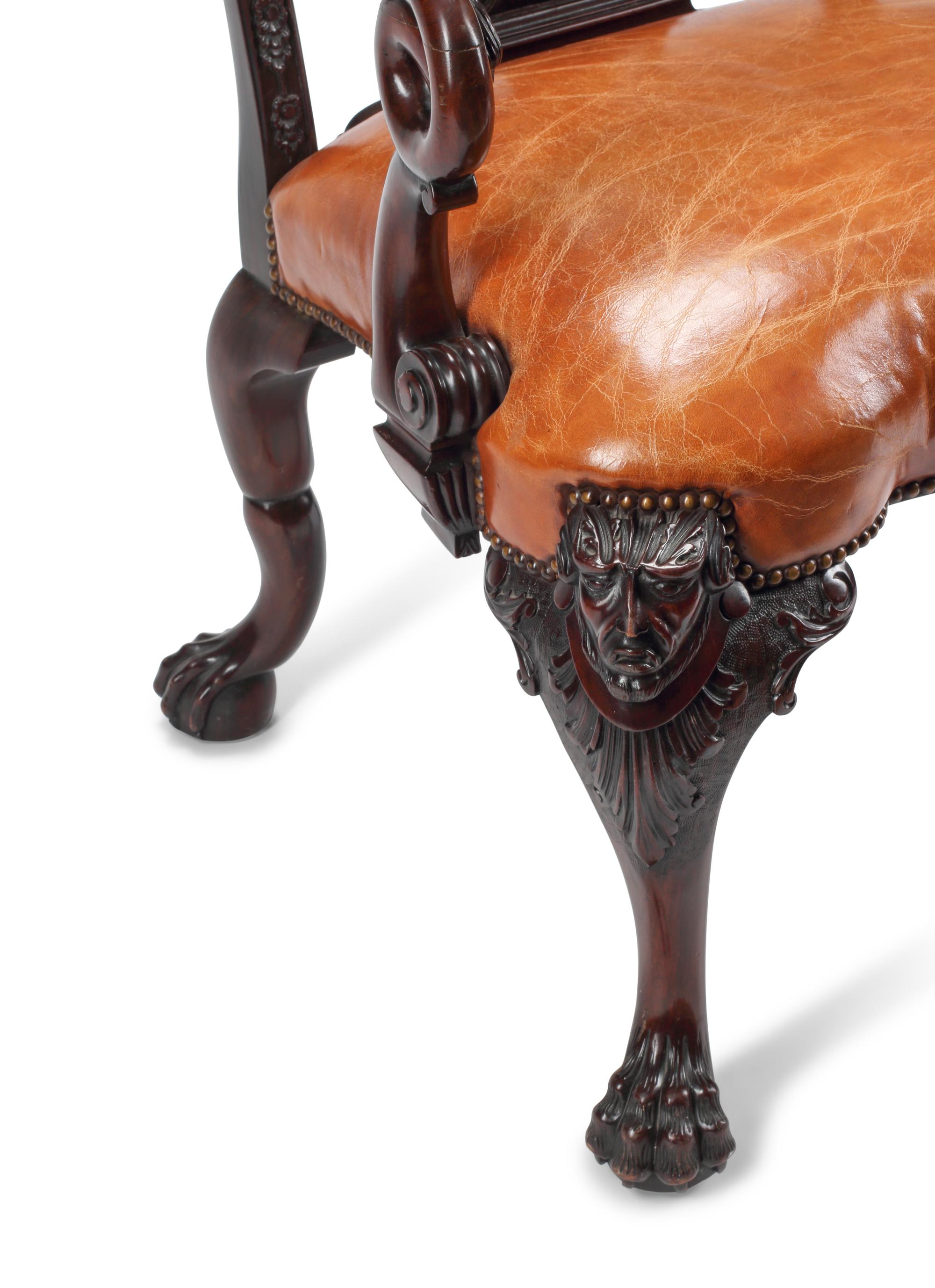 An English Carved Mahogany Leather-Upholstered Armchair