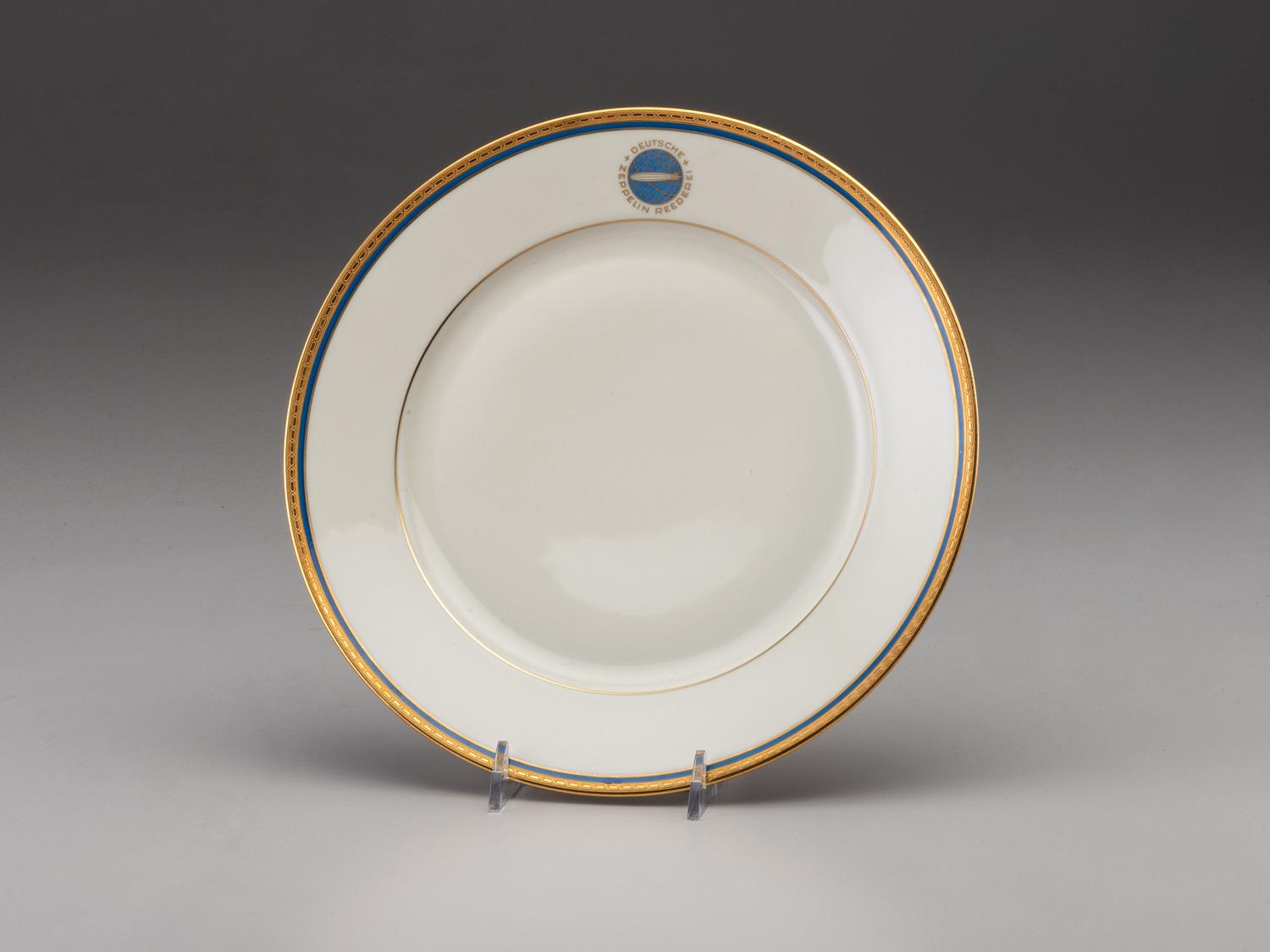 [TRANSPORTATION] - [ZEPPELIN]. Set of Deutsche Zeppelin-Reederei porcelain with dinner plates, salad plates, and sherbet glasses.