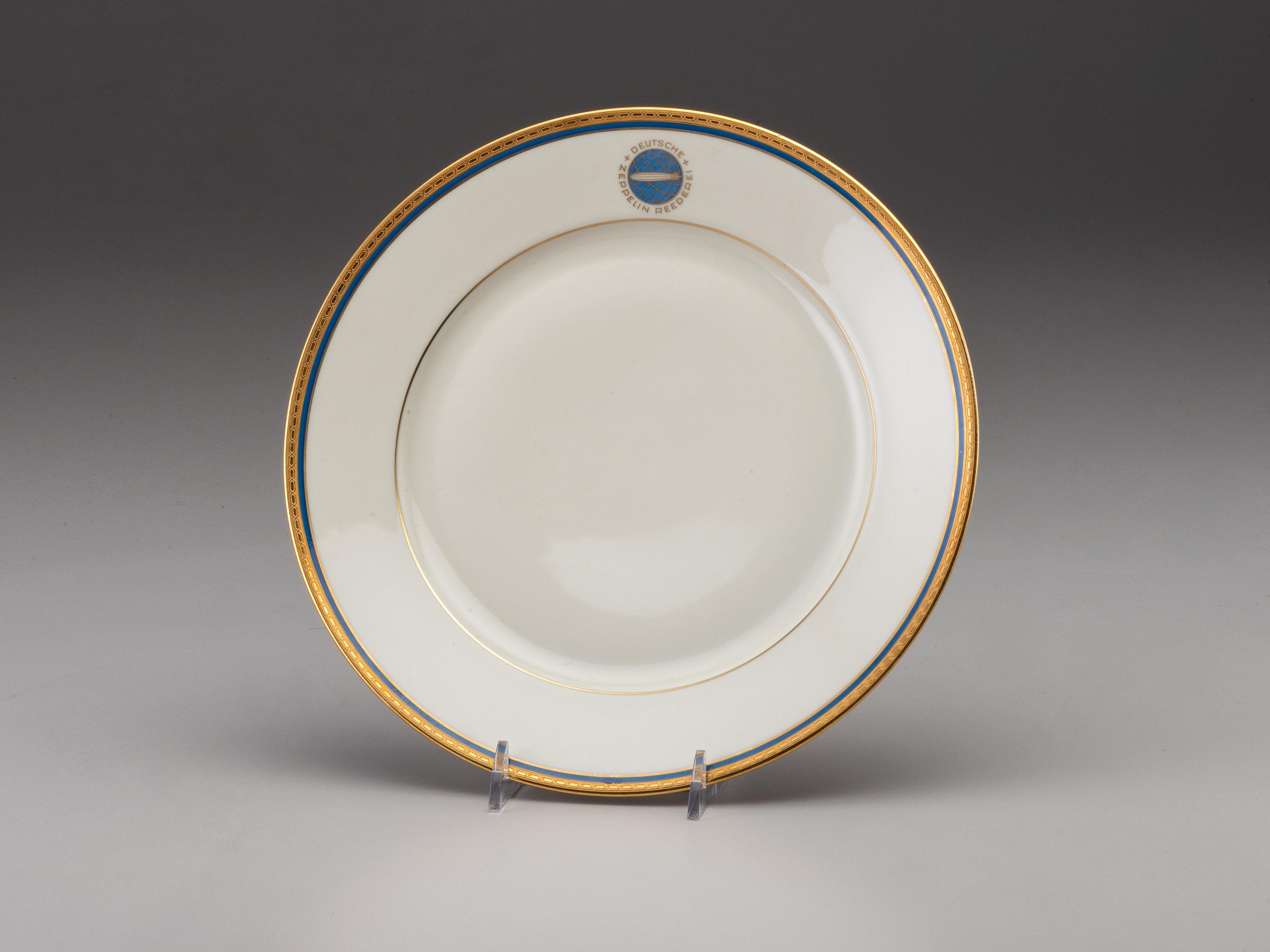 [TRANSPORTATION] - [ZEPPELIN]. Set of Deutsche Zeppelin-Reederei porcelain with dinner plates, salad plates, and sherbet glasses.