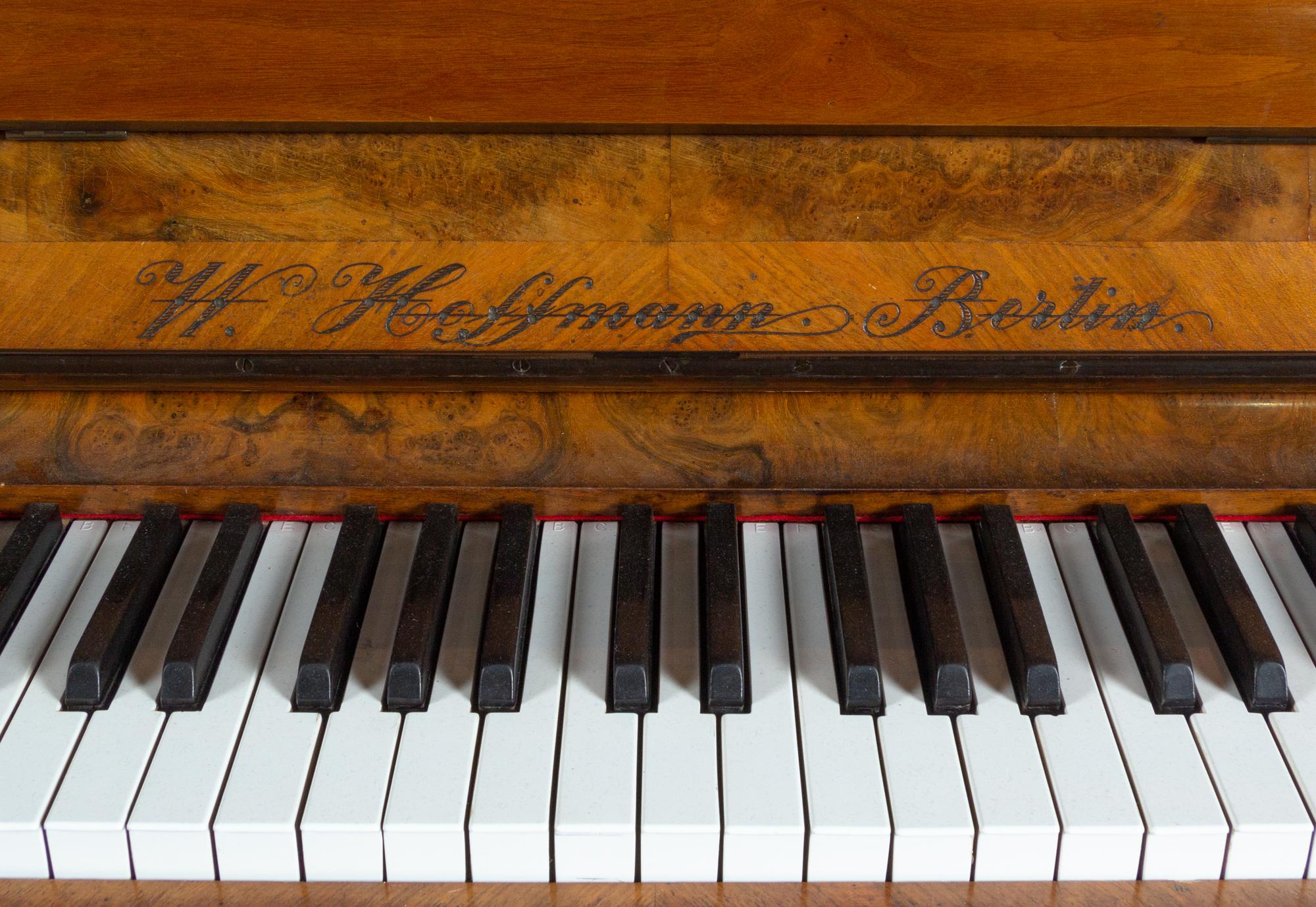 A German Carved Walnut Upright Player Piano and Upholstered Bench