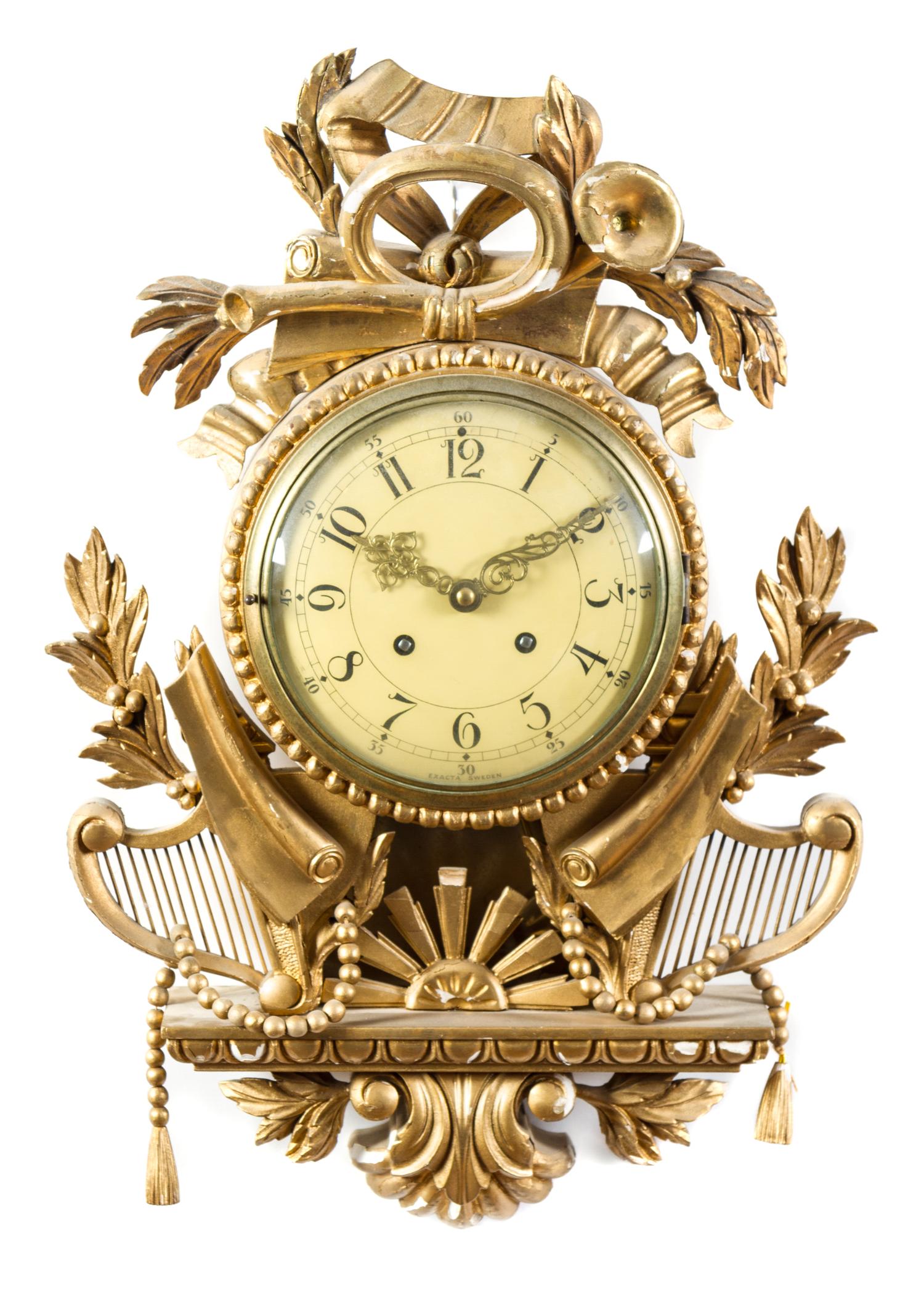 A Swedish Giltwood Cartel Clock Height 19 1/2 x width 13 3/4 x depth 4 1/2 inches. — 20TH CENTURY
