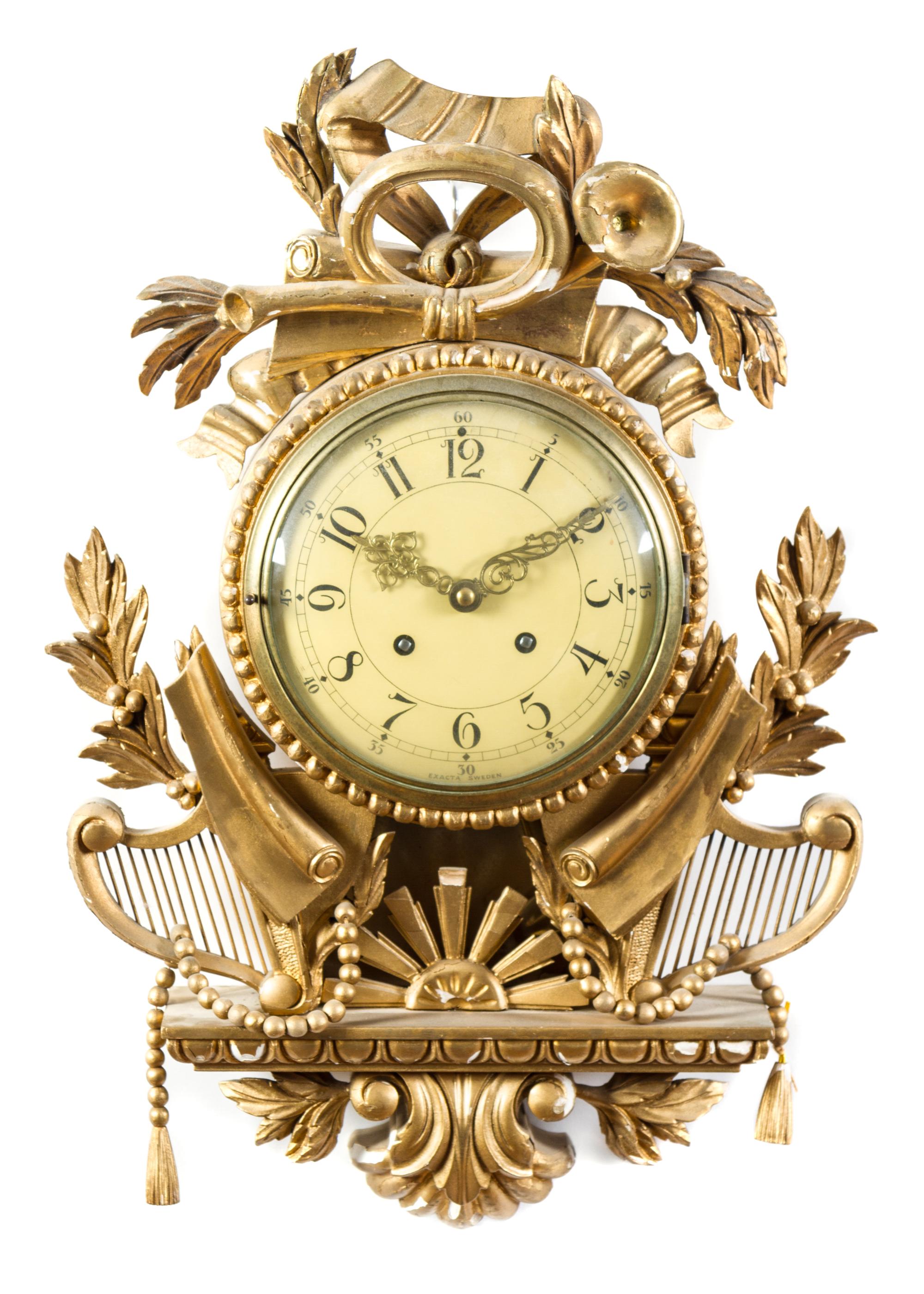 A Swedish Giltwood Cartel Clock Height 19 1/2 x width 13 3/4 x depth 4 1/2 inches. — 20TH CENTURY