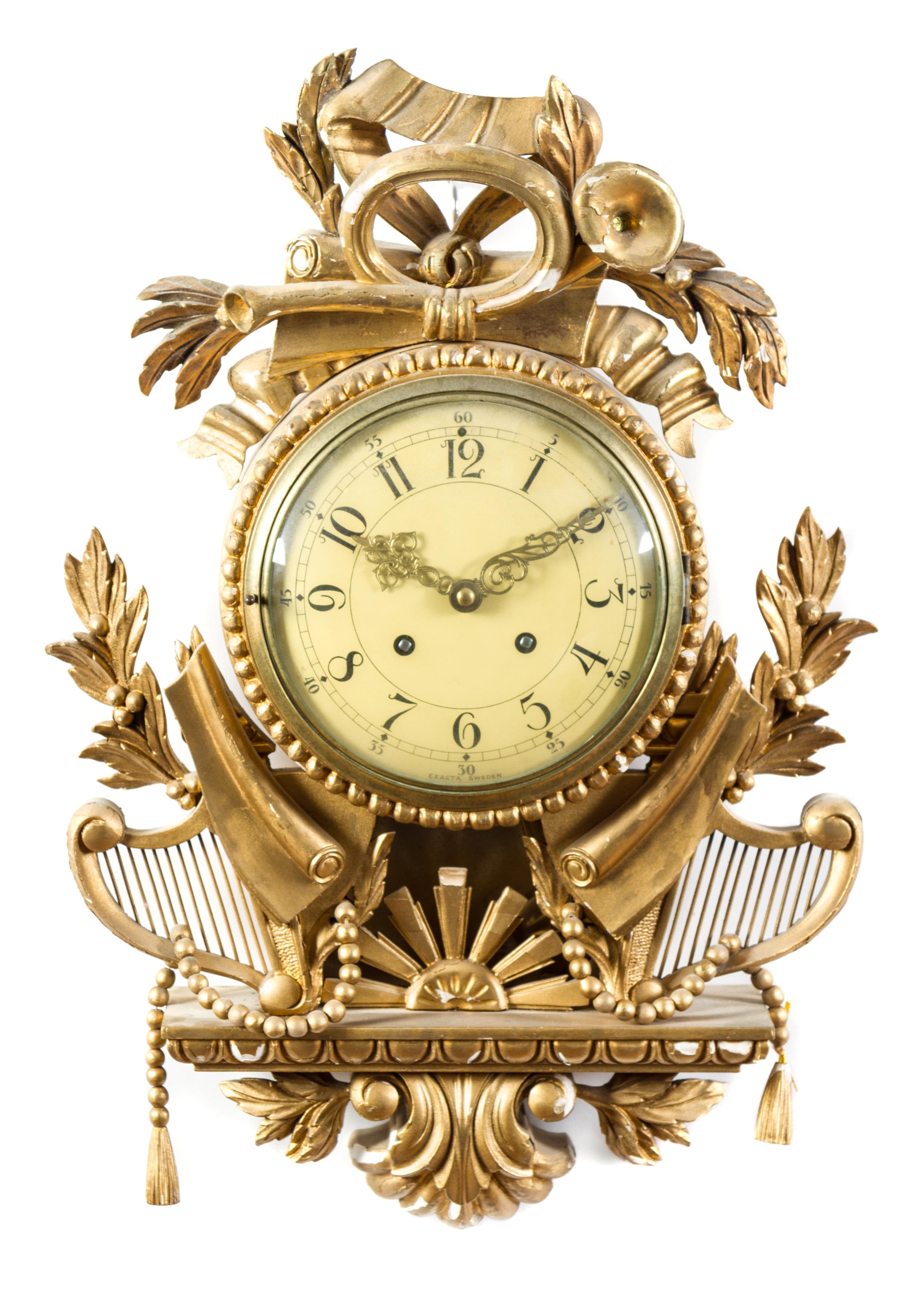 A Swedish Giltwood Cartel Clock Height 19 1/2 x width 13 3/4 x depth 4 1/2 inches. — 20TH CENTURY