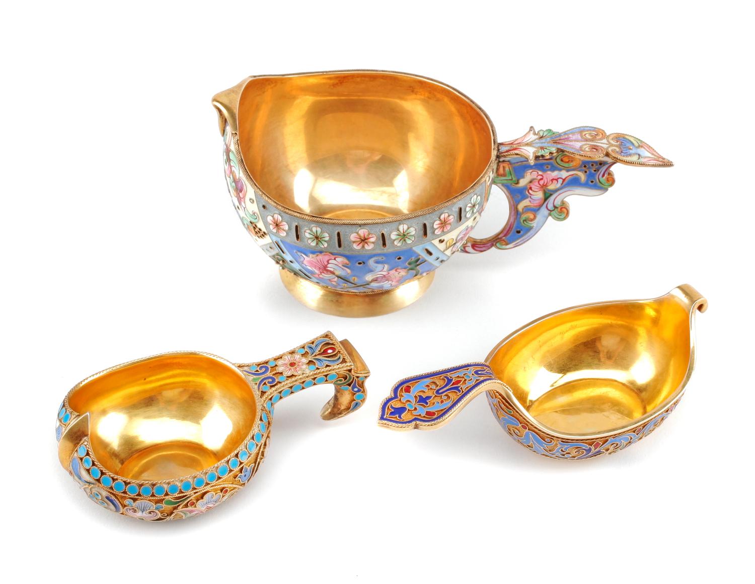 Three Russian Enameled Silver Kovshi, Various Makers, Late 19th/Early 20th Century, each having an exterior decorated with polychrome f