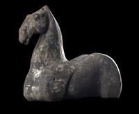A Chinese Grey Pottery Figure of a Recumbent Horse