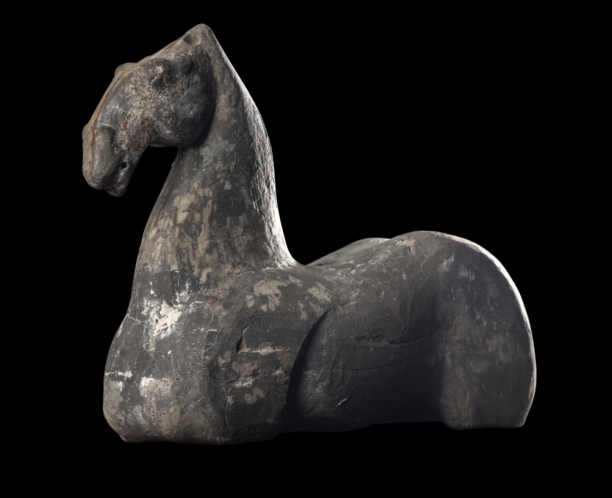 A Chinese Grey Pottery Figure of a Recumbent Horse