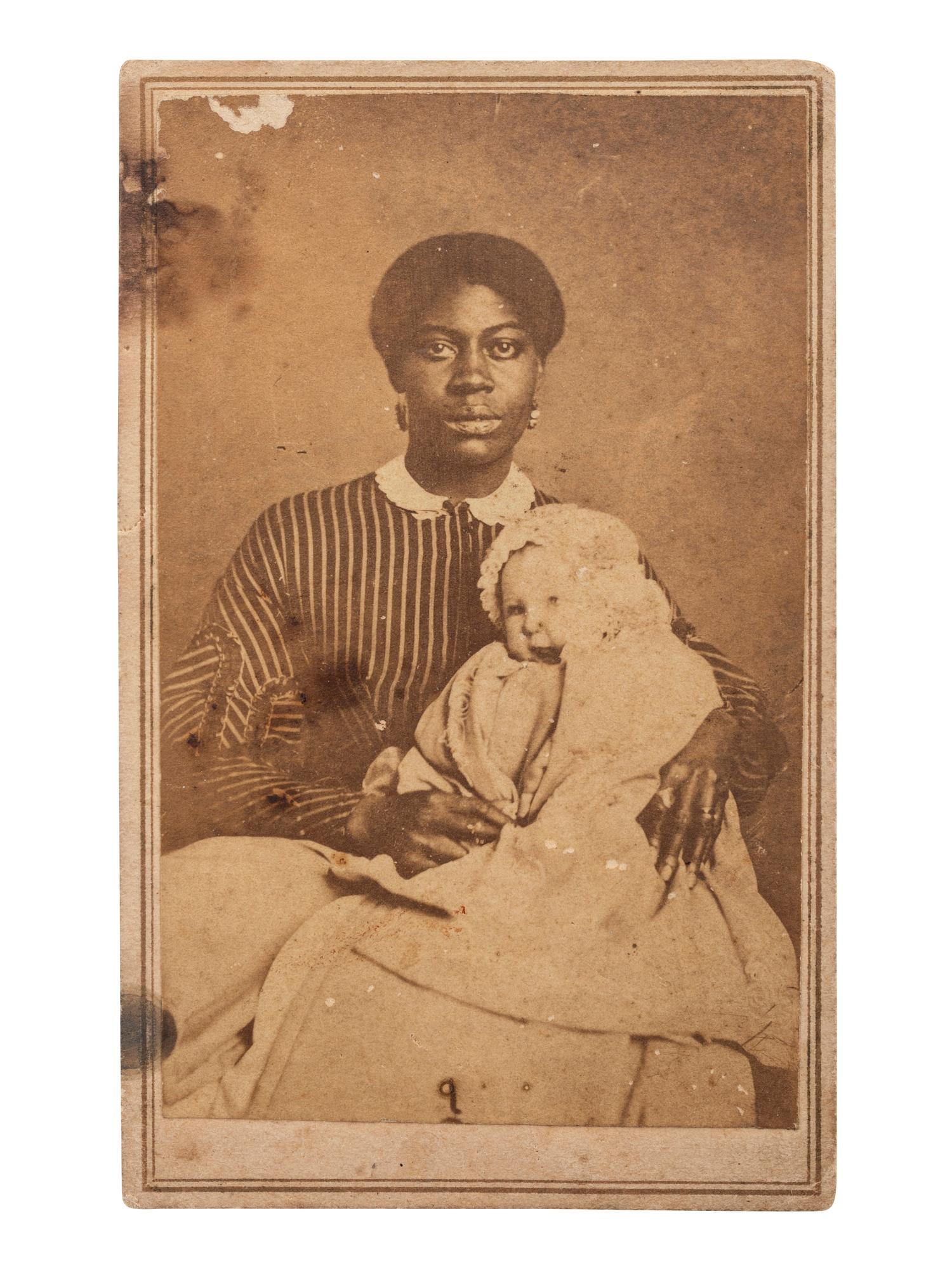 [EARLY PHOTOGRAPHY]. SCHLEIER, T.M., photographer. CDV of an African American nanny holding a white baby. Nashville, TN.