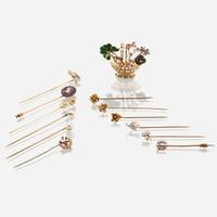 A collection of twelve gold and gem-set stick pins with brooch