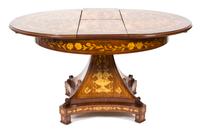 A Dutch Mahogany and Fruitwood Marquetry Center Table Height 31 1/2 x diameter 41 1/2 inches. Extension width 13 1/2 inches. — 20TH CENTURY
