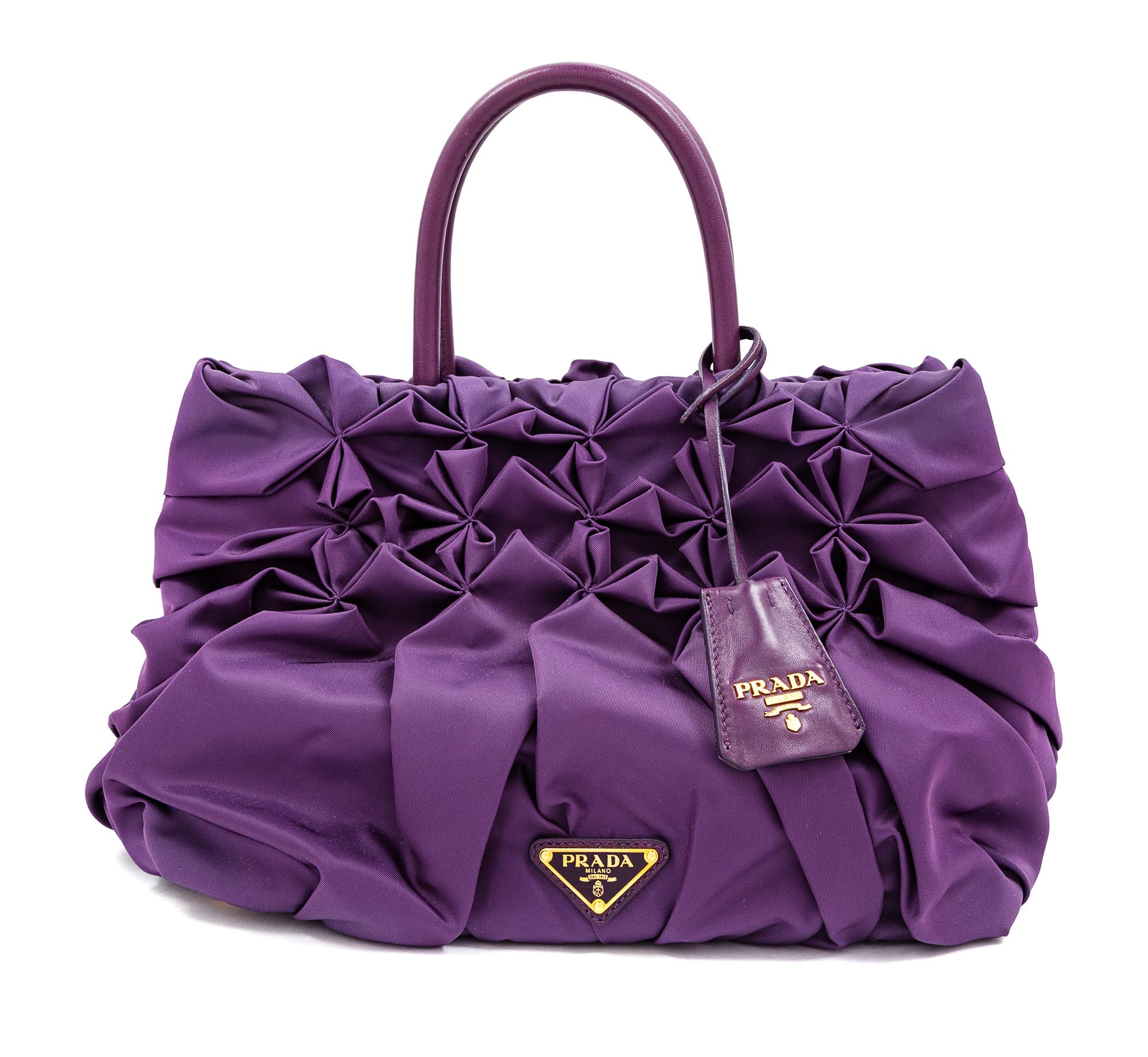 A Prada Purple Tessuto Nylon Origami Handbag with Leather Gloves and Earmuffs, Handbag: 7.5" H x 14" W x 8.25" D; Handle drop: 4.25". G