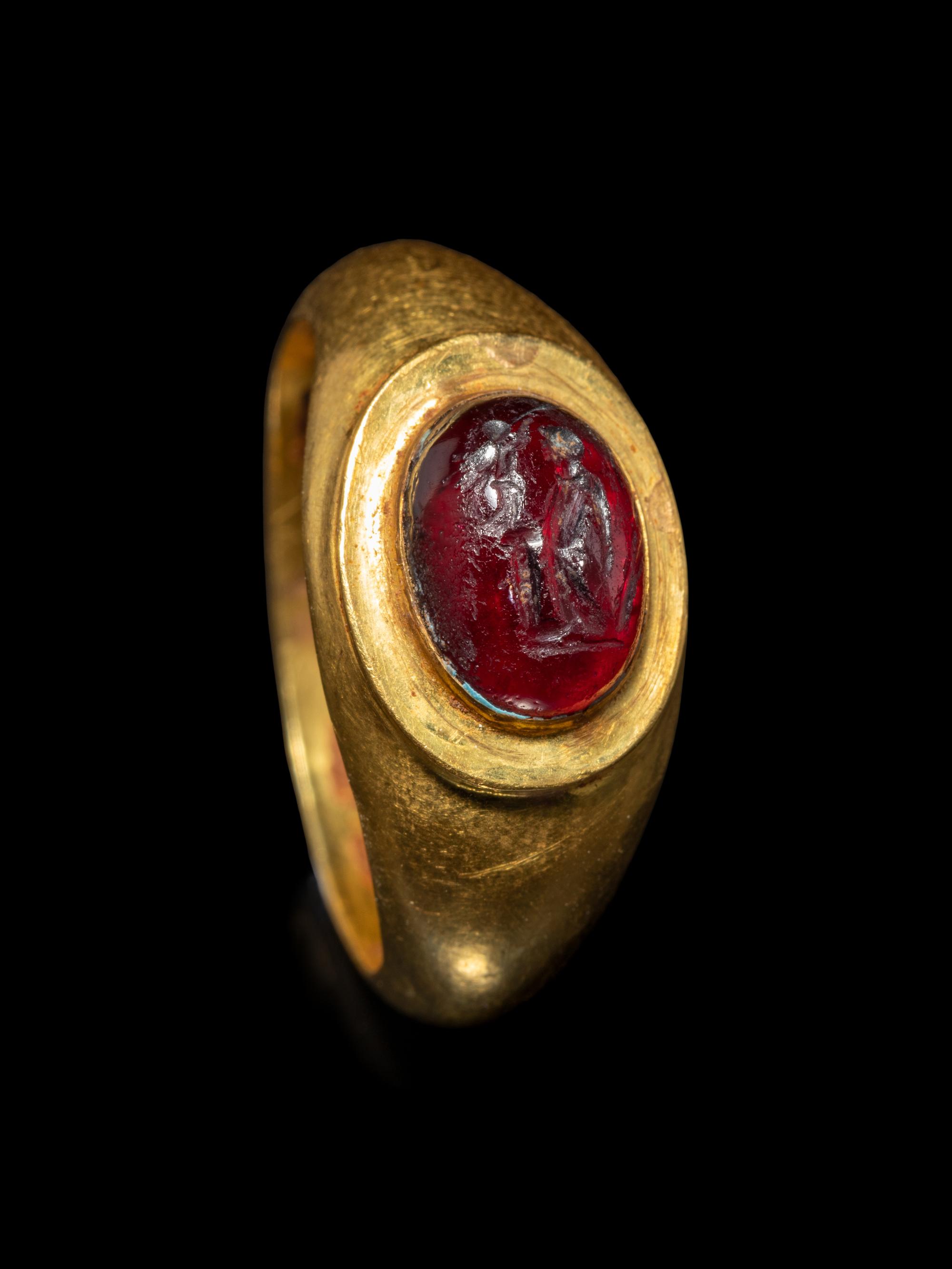 A Roman Gold and Garnet Finger Ring with the Goddesses Athena and Nike