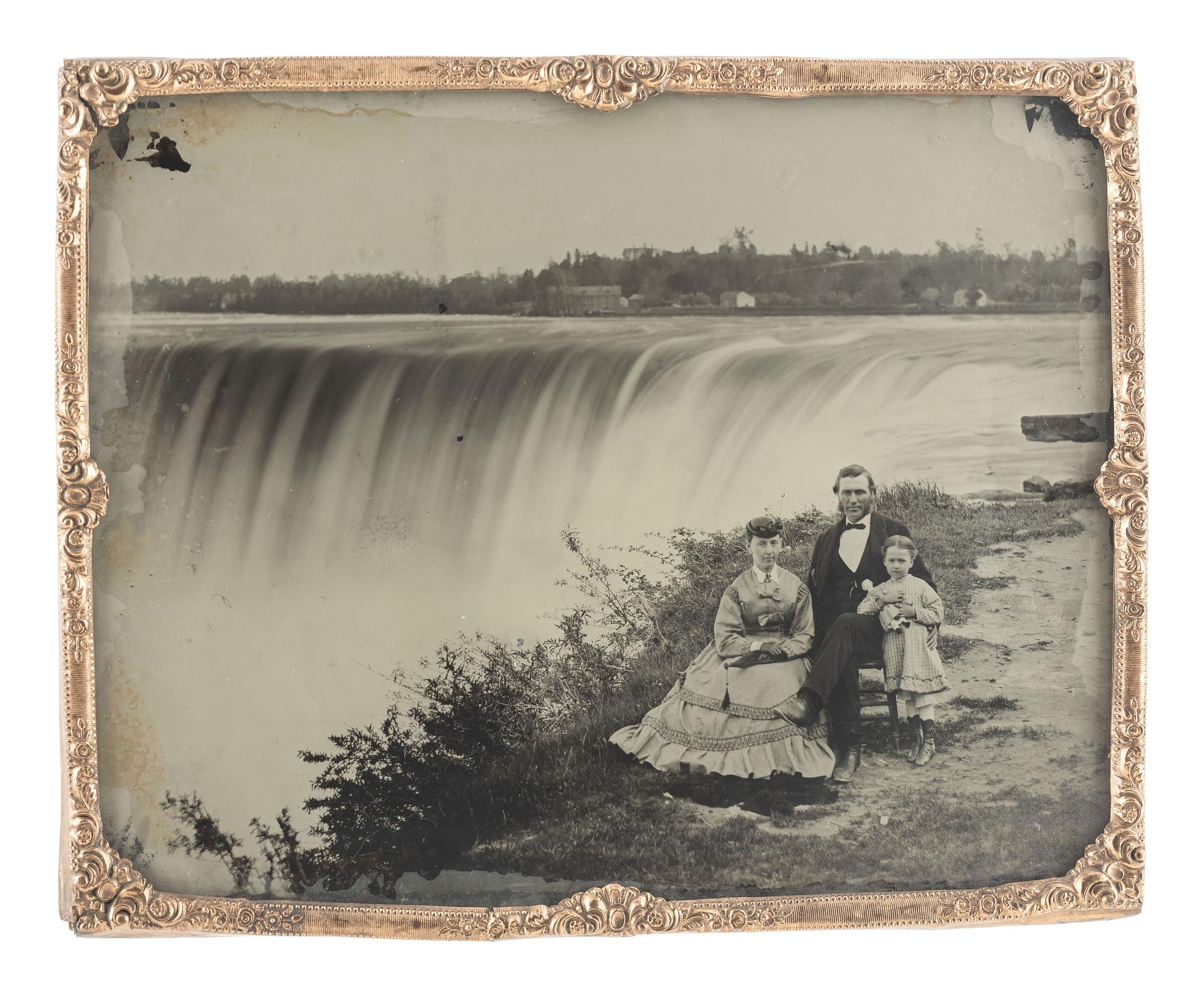 [EARLY PHOTOGRAPHY]. Whole plate ambrotype of a family of three posed in front of Niagara Falls.