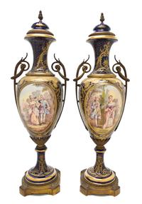 A Pair of Sevres Style Porcelain and Gilt Metal Mounted Urns, Height overall 25 inches.