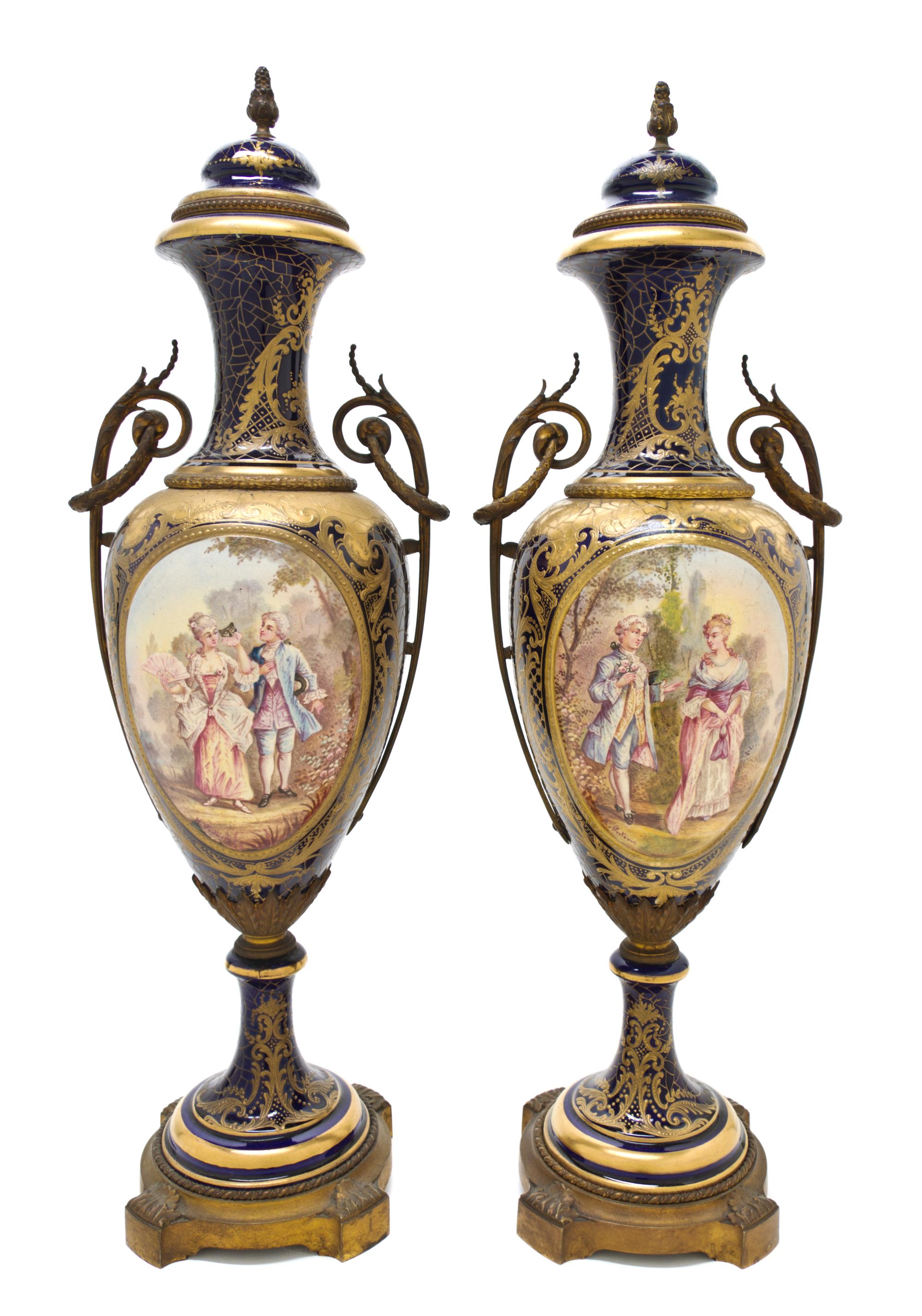 A Pair of Sevres Style Porcelain and Gilt Metal Mounted Urns, Height overall 25 inches.