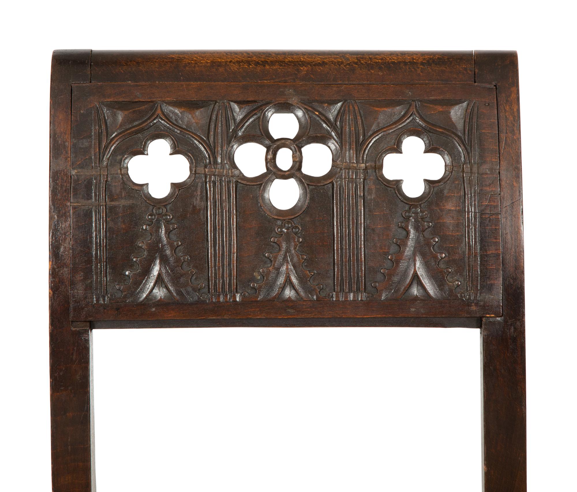 A Pair of Continental Carved Oak 'Gothic' Folding Chairs