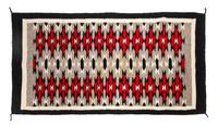 A Navajo Yei Rug First: 33 x 21 inches.