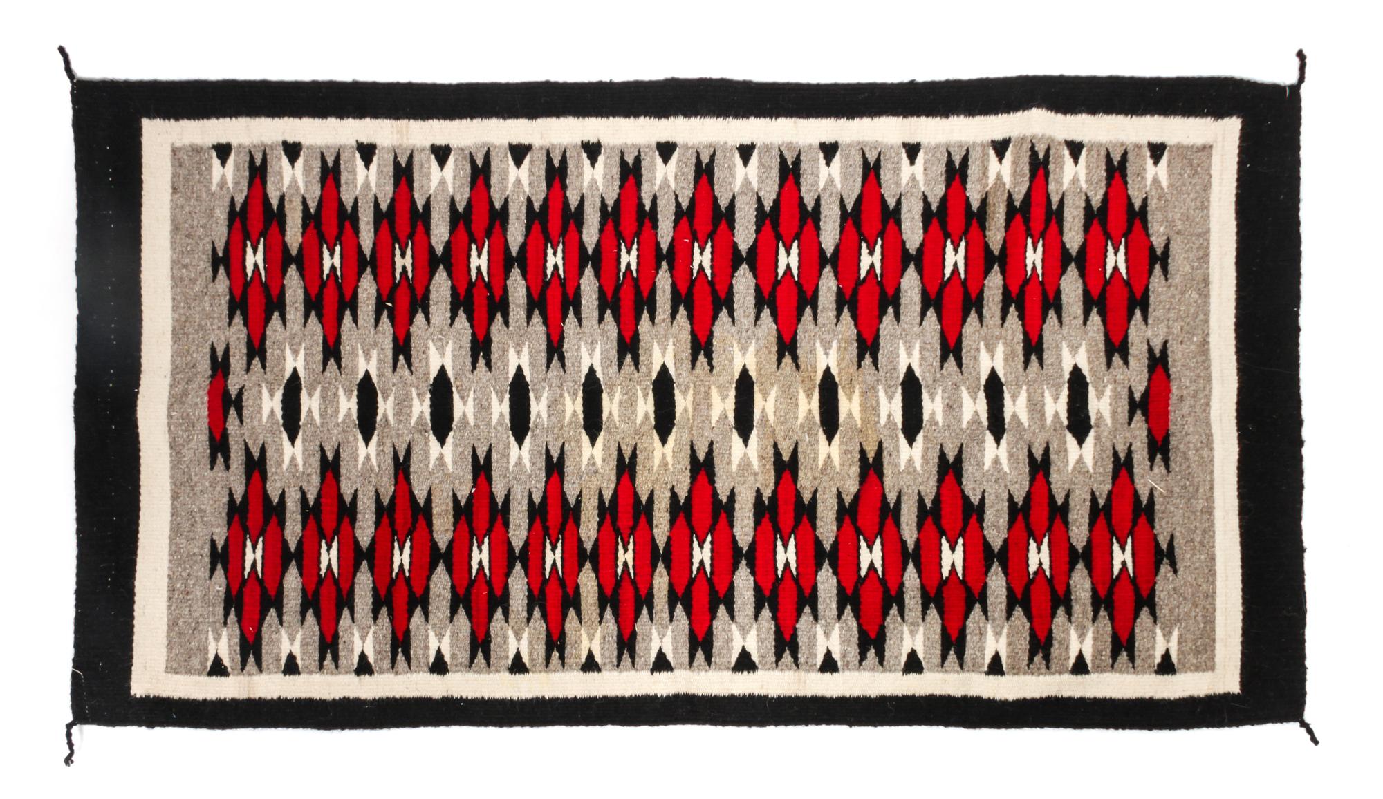 A Navajo Yei Rug First: 33 x 21 inches.
