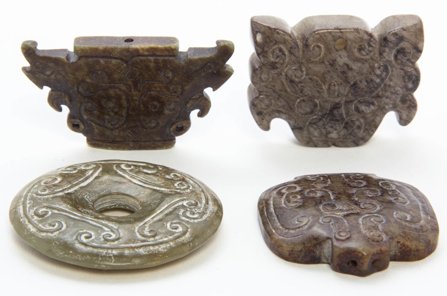 A Group of Three Carved Jade Toggles Width of widest 2 5/8 inches.