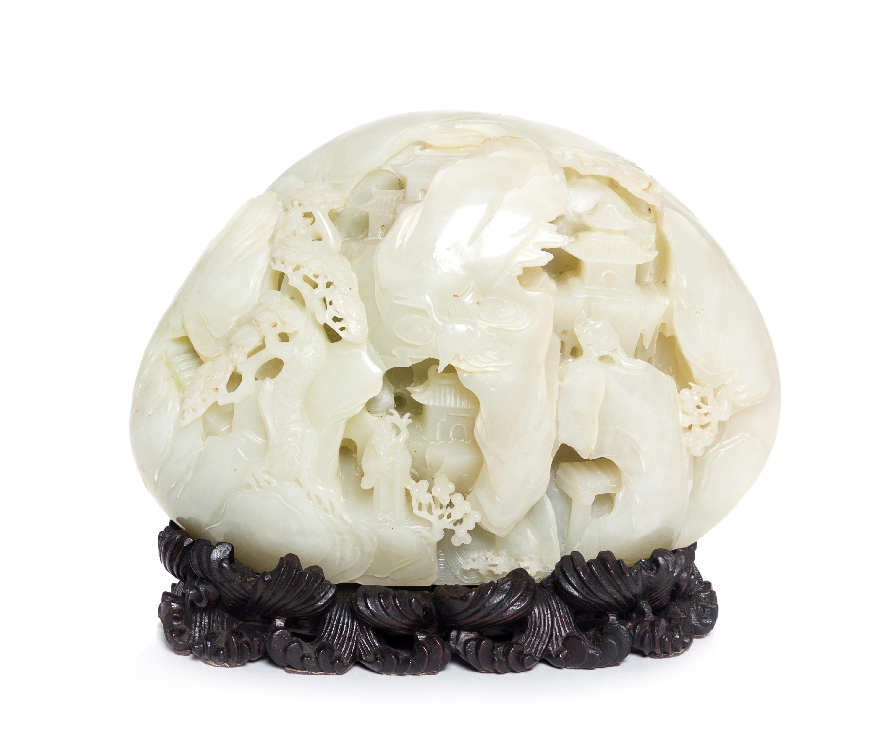 A Carved Pale Celadon Jade Boulder Height 7 x width 8 inches.