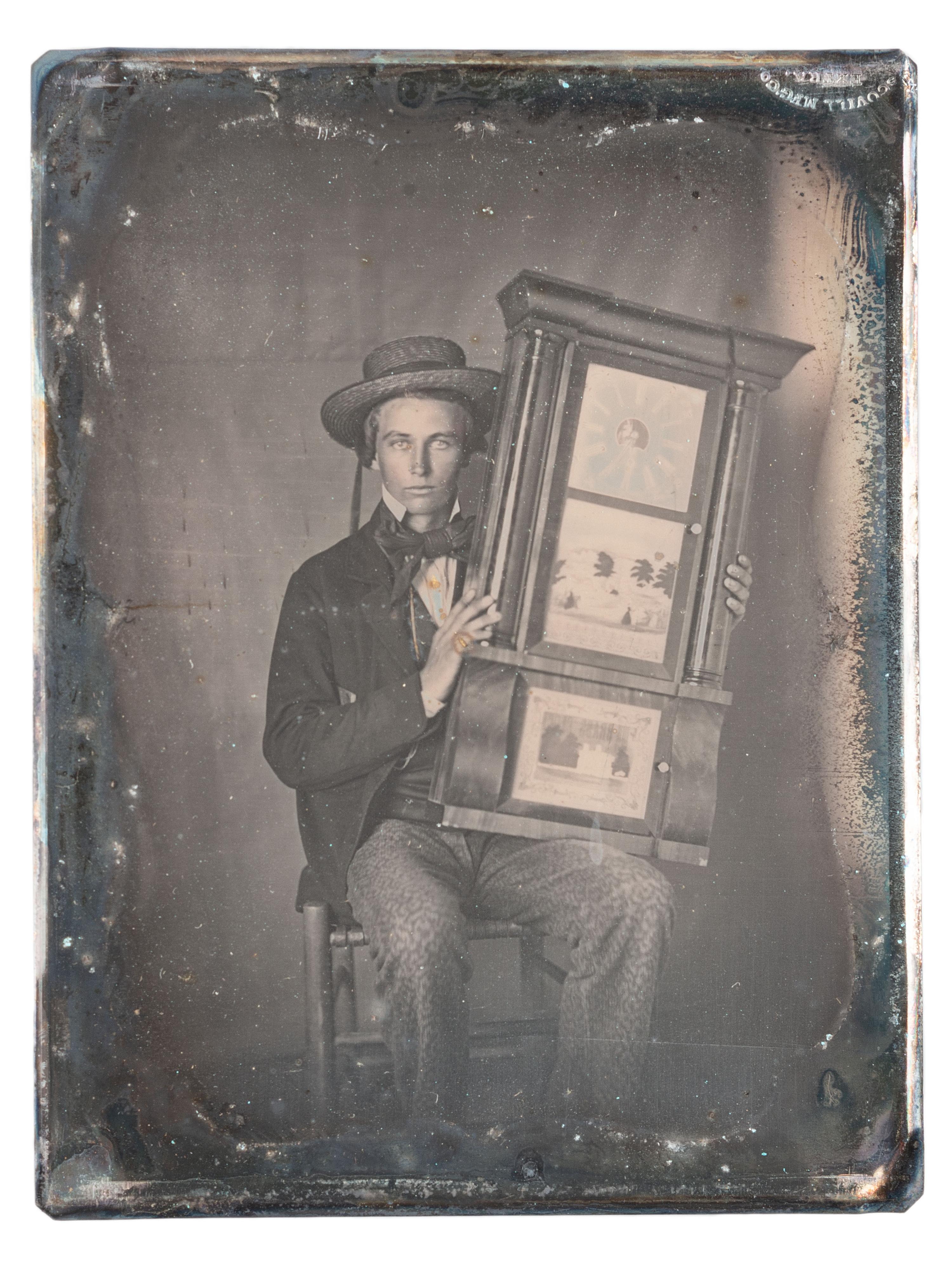 [EARLY PHOTOGRAPHY]. Quarter plate daguerreotype of a young man holding a clock.