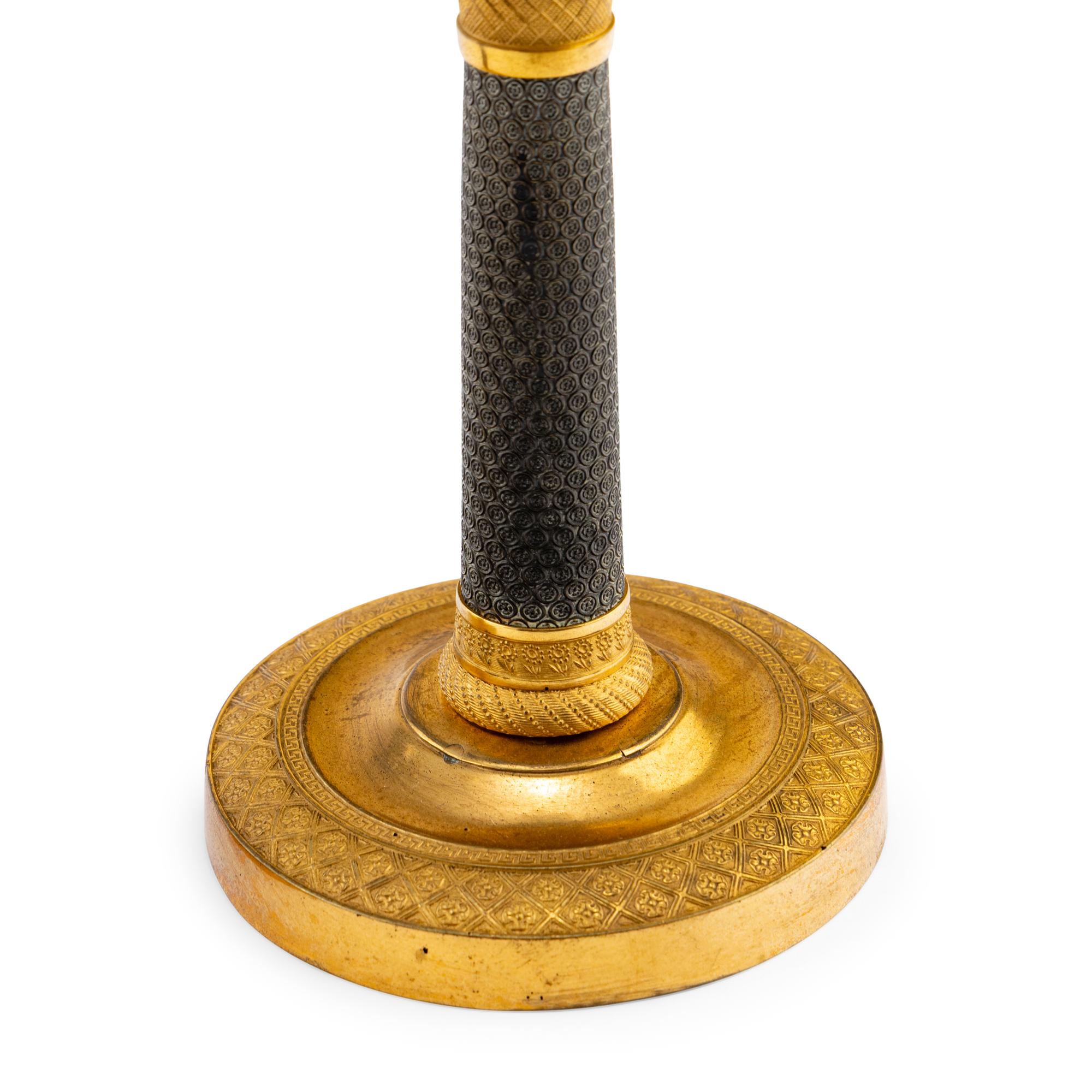 A Pair of Continental Gilt and Patinated Bronze Candlesticks