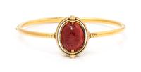 An Egyptian Revival Yellow Gold, Carved Carnelian Scarab and Enamel Bangle Bracelet, Carlo Giuliano, 8.50 dwts.