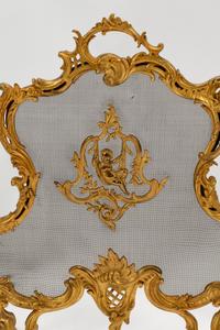 A Pair of Louis XV Style Gilt Bronze Chenets and a Similar Fire Screen