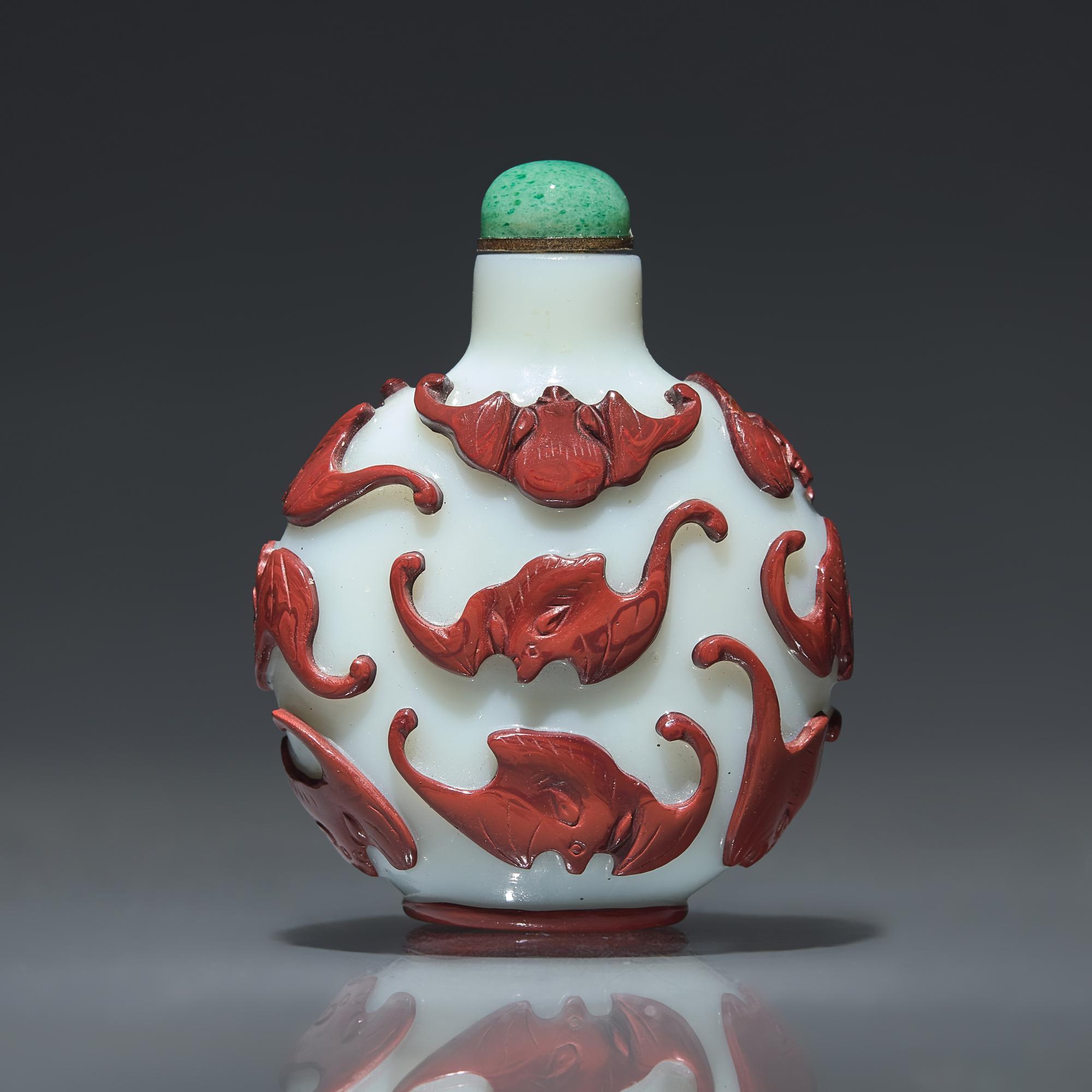 A Chinese Carved Red-Overlaid White Glass "Bats" Snuff Bottle, Qing Dynasty, Circa 1780-1850 — 1780-1850年 涅白地套紅料蝙蝠紋鼻煙壺