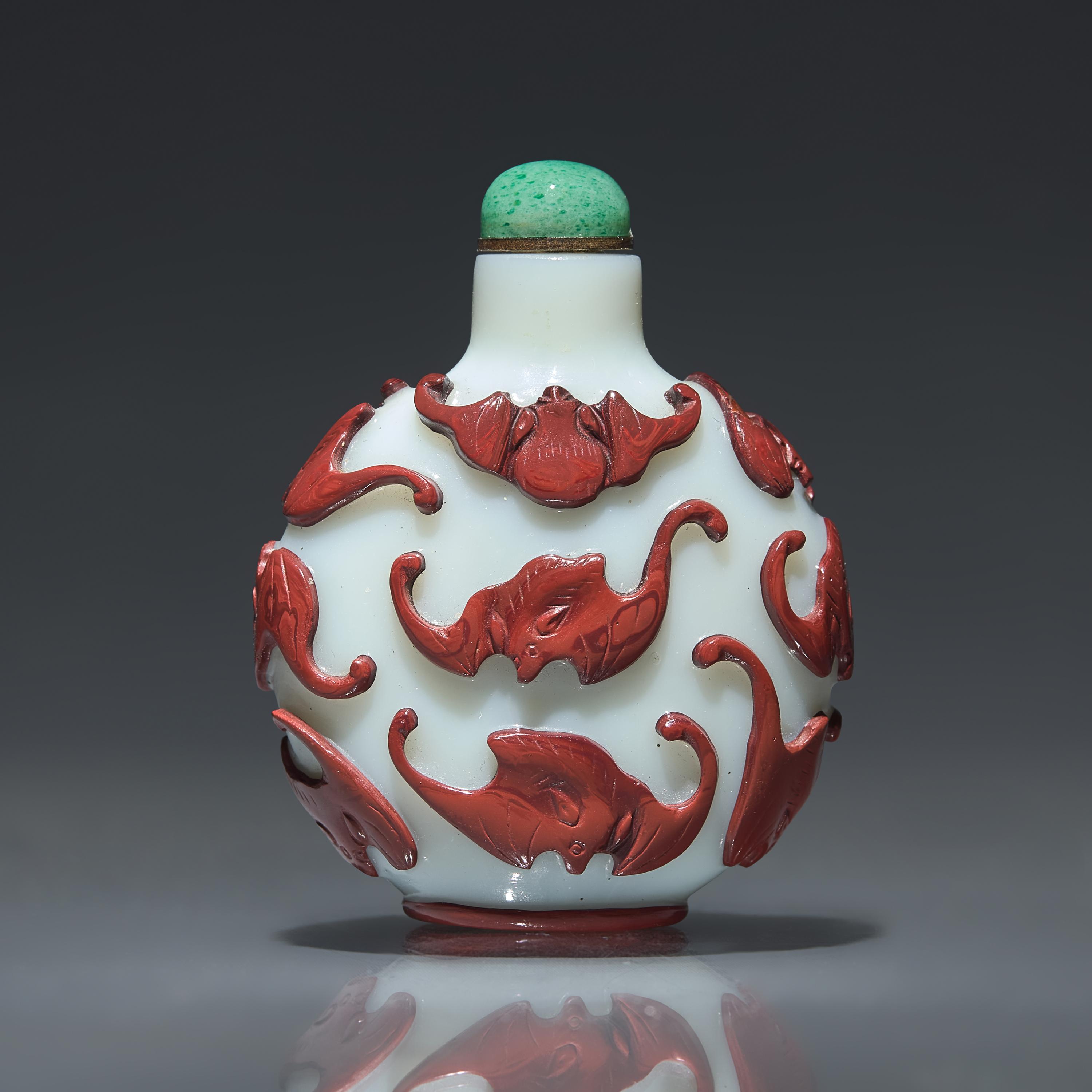 A Chinese Carved Red-Overlaid White Glass "Bats" Snuff Bottle, Qing Dynasty, Circa 1780-1850 — 1780-1850年 涅白地套紅料蝙蝠紋鼻煙壺