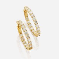 A pair of diamond and gold earrings