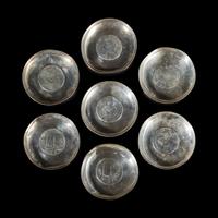 A Group of Seven Chinese Silver Coin-Mounted Small Dishes, 20th Century — 近代 銀嵌機制幣小碟一組七件