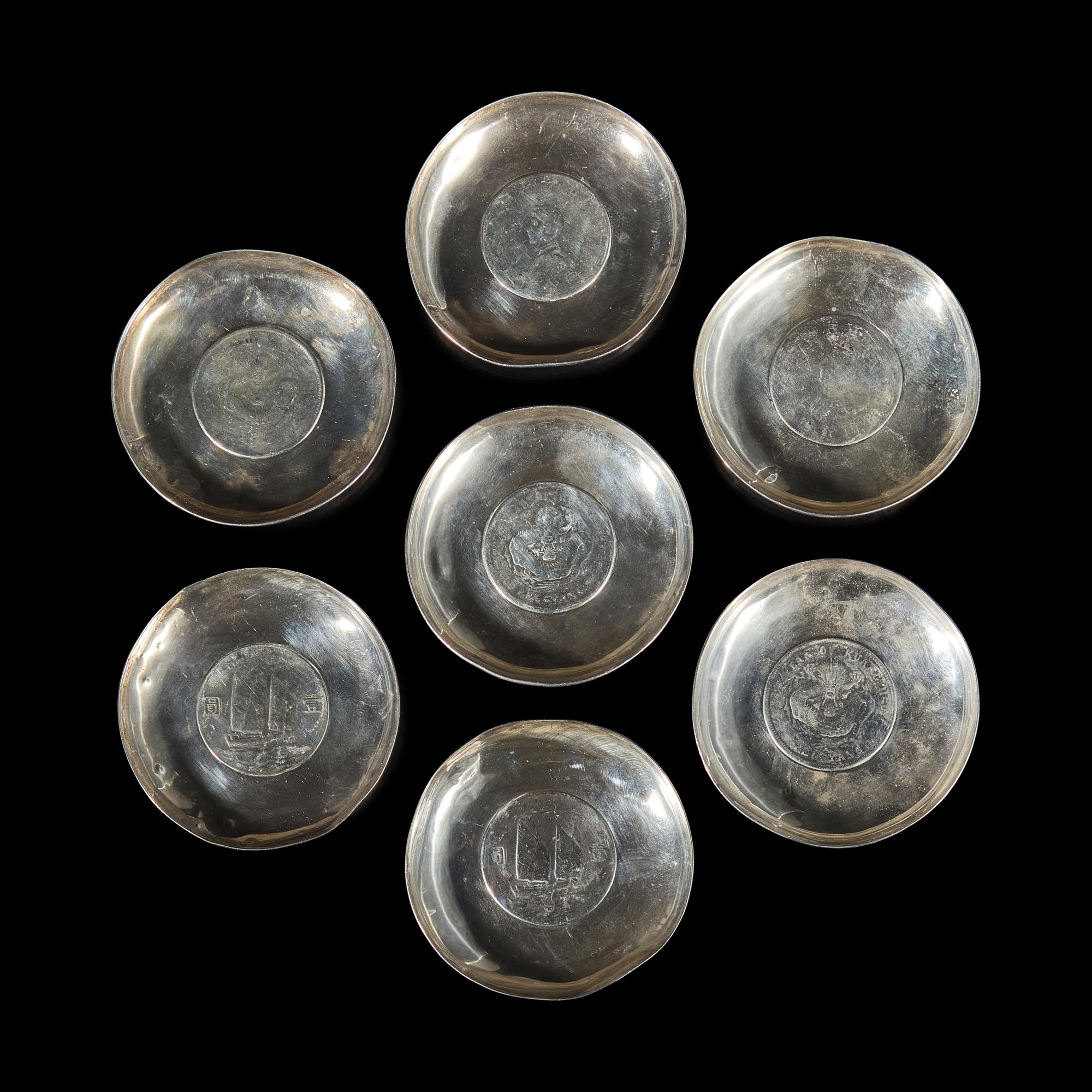 A Group of Seven Chinese Silver Coin-Mounted Small Dishes, 20th Century — 近代 銀嵌機制幣小碟一組七件