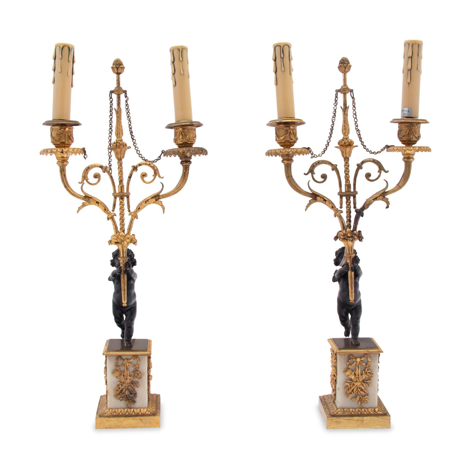 A Pair of French Gilt Metal and Marble Figural Two-Light Candelabra