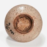 A Japanese iron-brown decorated small stoneware dish Signed "Kenzan"