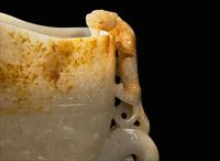 A large Chinese carved pale celadon and russet jade rhyton vessel 青白玉雕觥杯