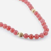 A rhodochrosite and 18K yellow gold bead necklace with citrine and gold brooch