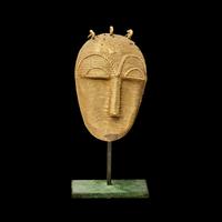 A Lagoons Region Gilt-Brass Mask Pendant