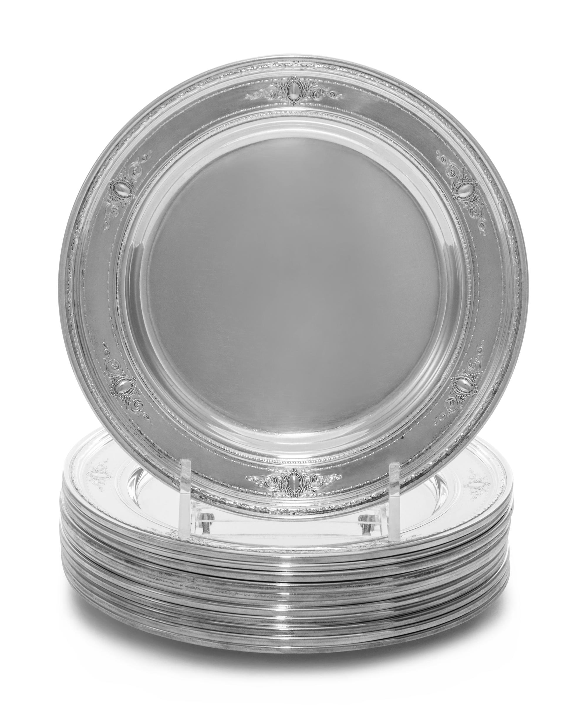 A Set of Twelve American Silver Bread Plates, Reed & Barton, Taunton, MA, with vacant catouches issuing foliate scrolls at intervals ar