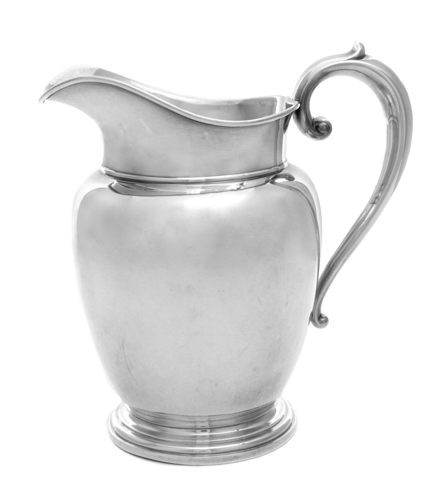 An American Silver Water Pitcher, Manchester Silver Company, Providence, RI, having a baluster form body with a C-scroll handle.