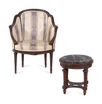 A Louis XVI Style Carved Walnut Bergère and Side Table