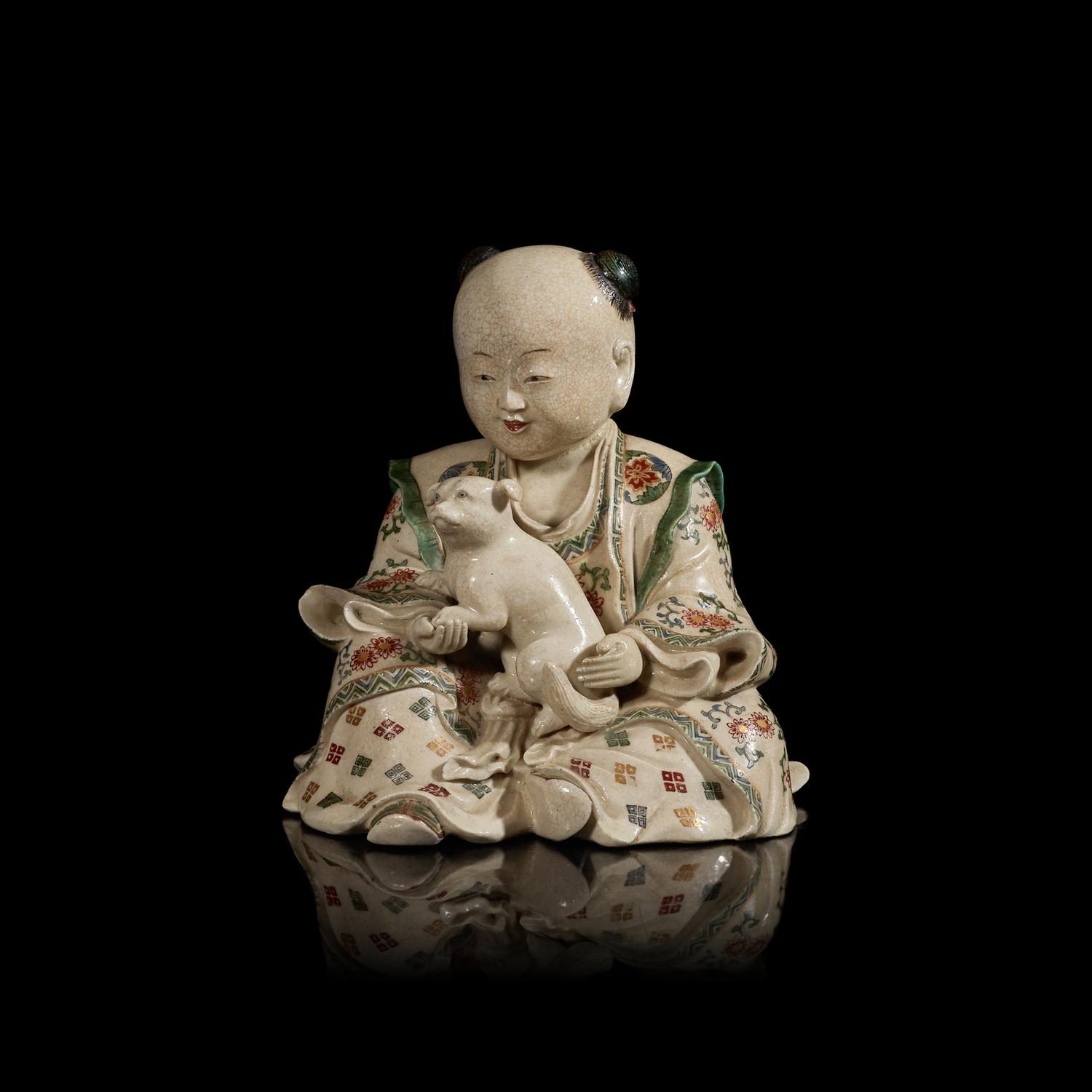 A Japanese Satsuma Type Stoneware Figure of a Boy, Late Edo to Meiji Period