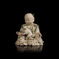 A Japanese Satsuma Type Stoneware Figure of a Boy, Late Edo to Meiji Period