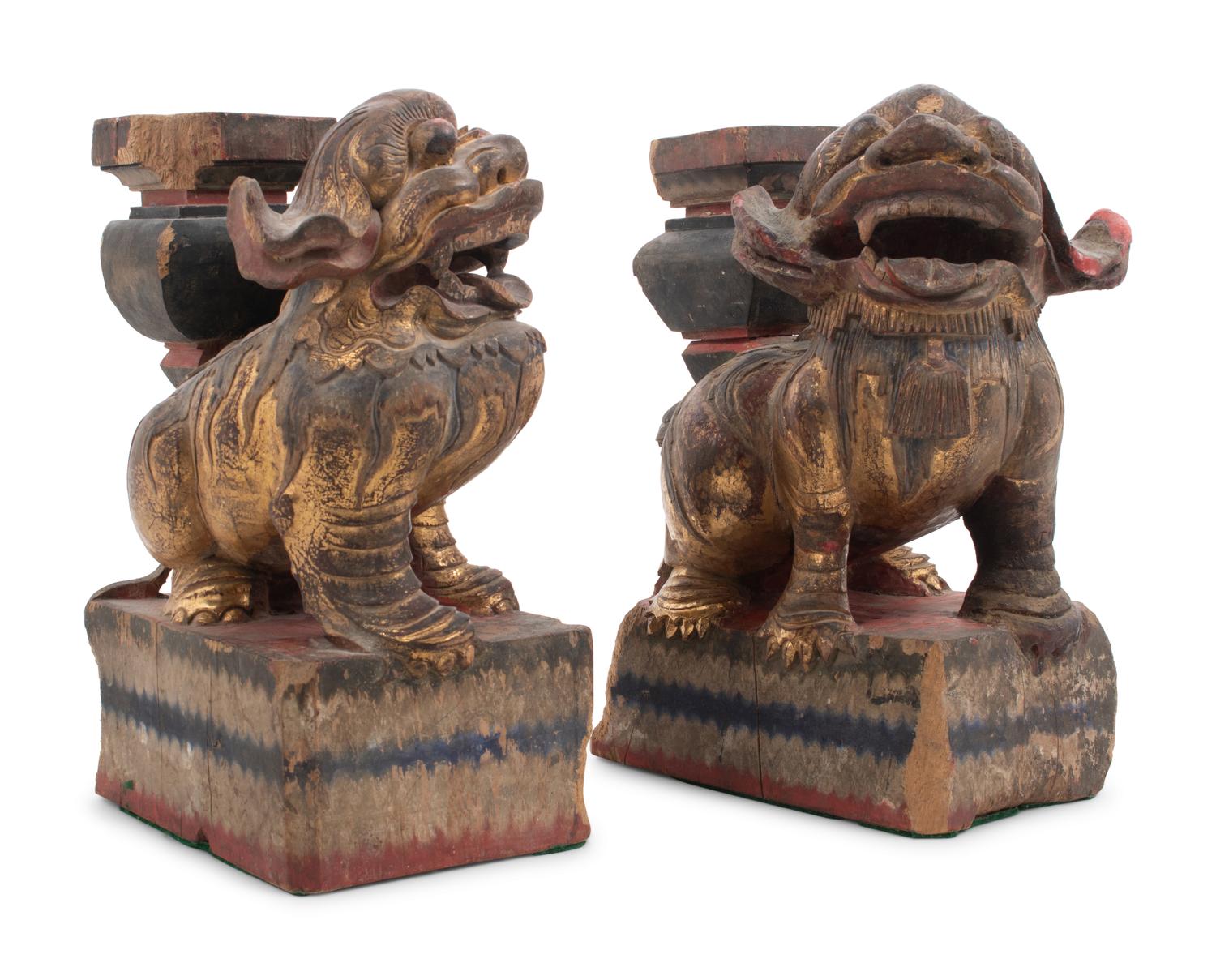 A Pair of Chinese Giltwood Candlesticks with Buddhistic Lions