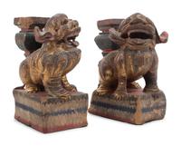 A Pair of Chinese Giltwood Candlesticks with Buddhistic Lions
