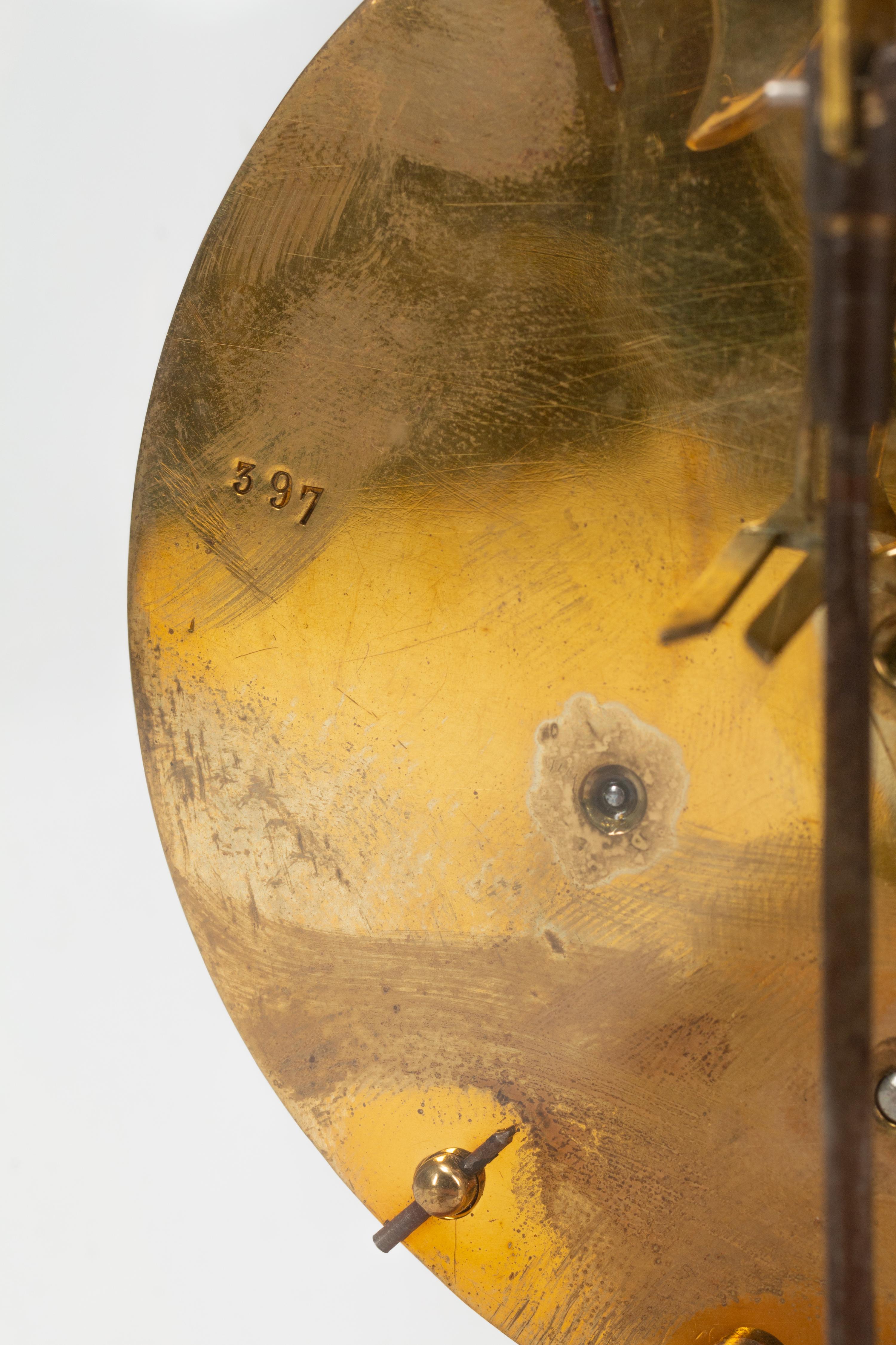 A Continental Gilt Bronze Skeleton Clock and Glass Dome