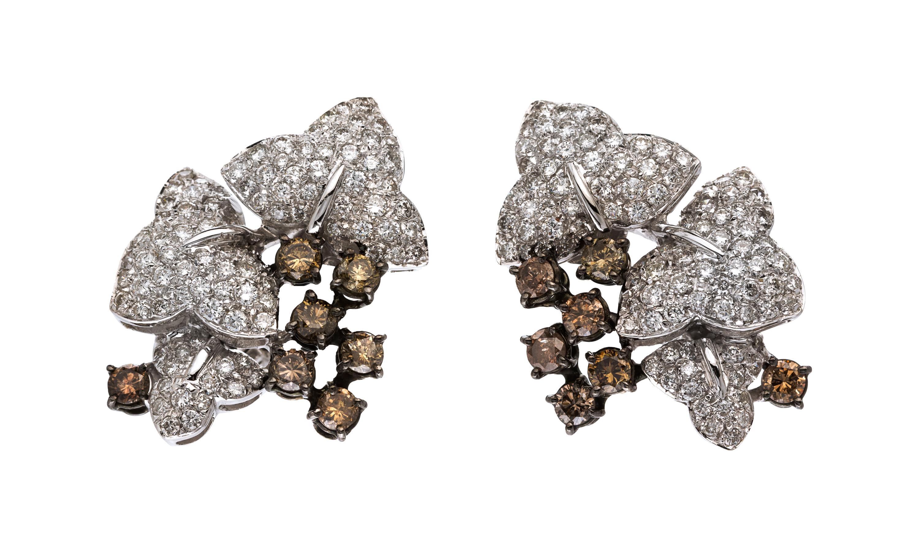 A Pair of 18 Karat White Gold, Colored Diamond and Diamond Earclips, 13.70 dwts.